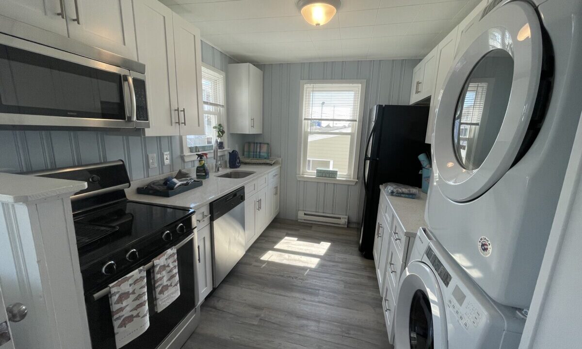 a kitchen with a washer and dryer in it.