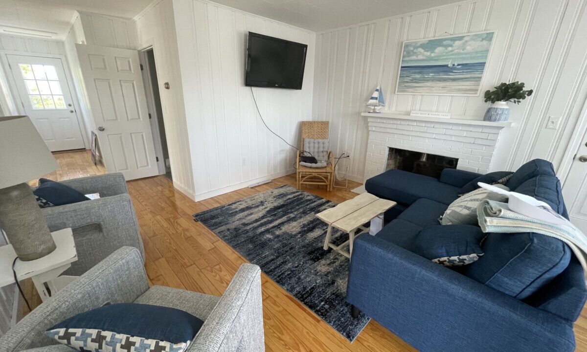 a living room filled with furniture and a flat screen tv.