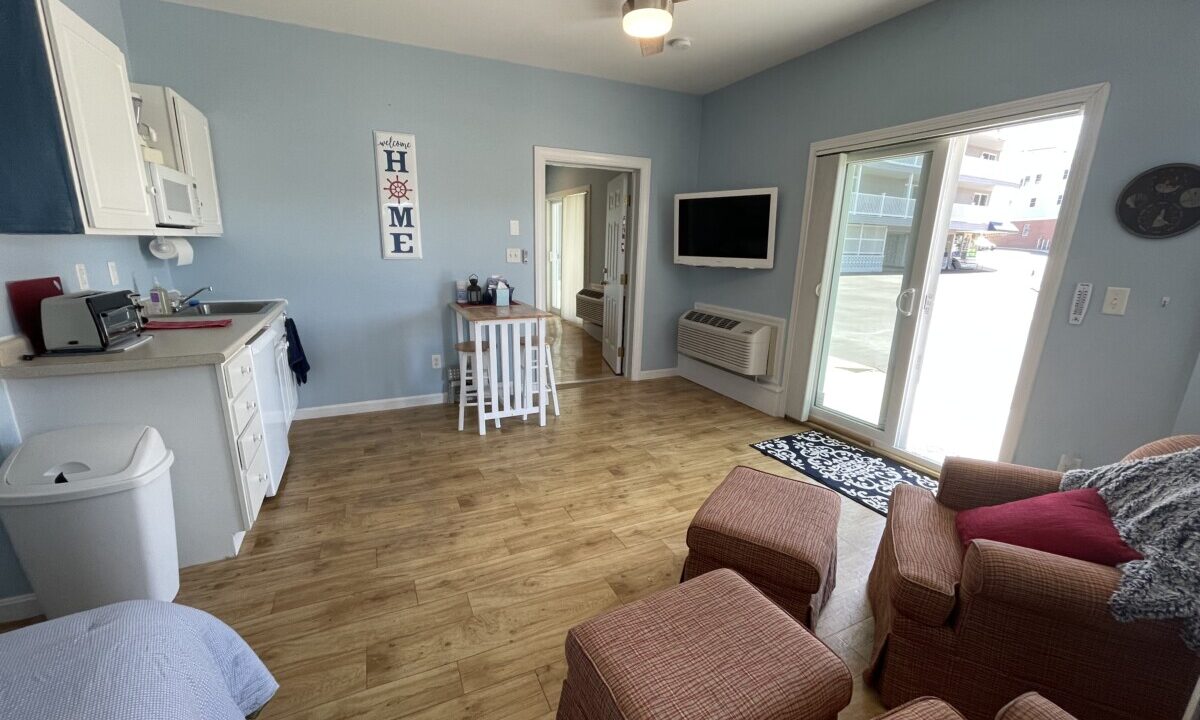 a living room filled with furniture and a flat screen tv.