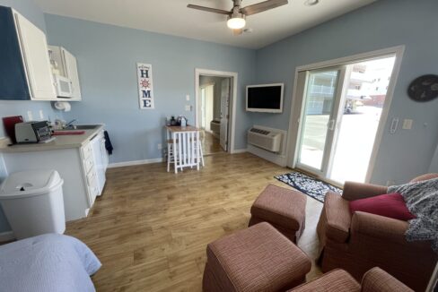 a living room filled with furniture and a flat screen tv.