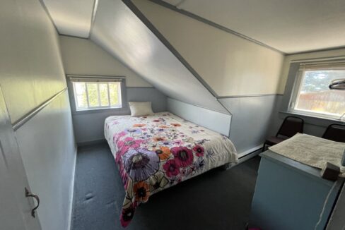 a bedroom with a bed and a desk in it.