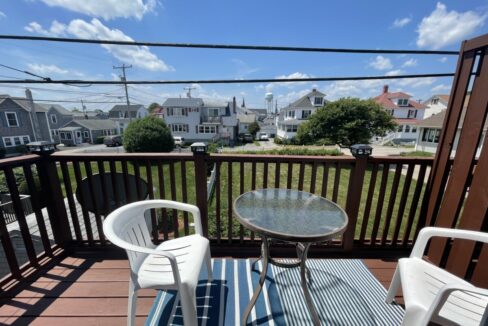 two chairs and a table on a deck.