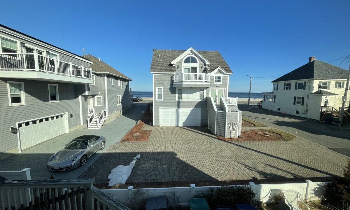 a car is parked in front of some houses.