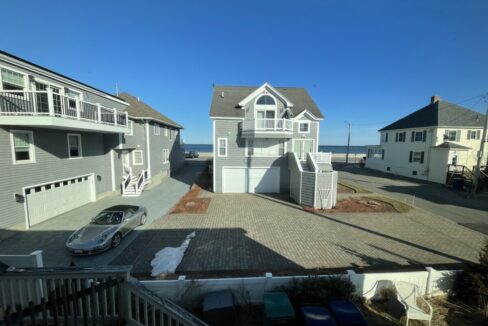 a car is parked in front of some houses.