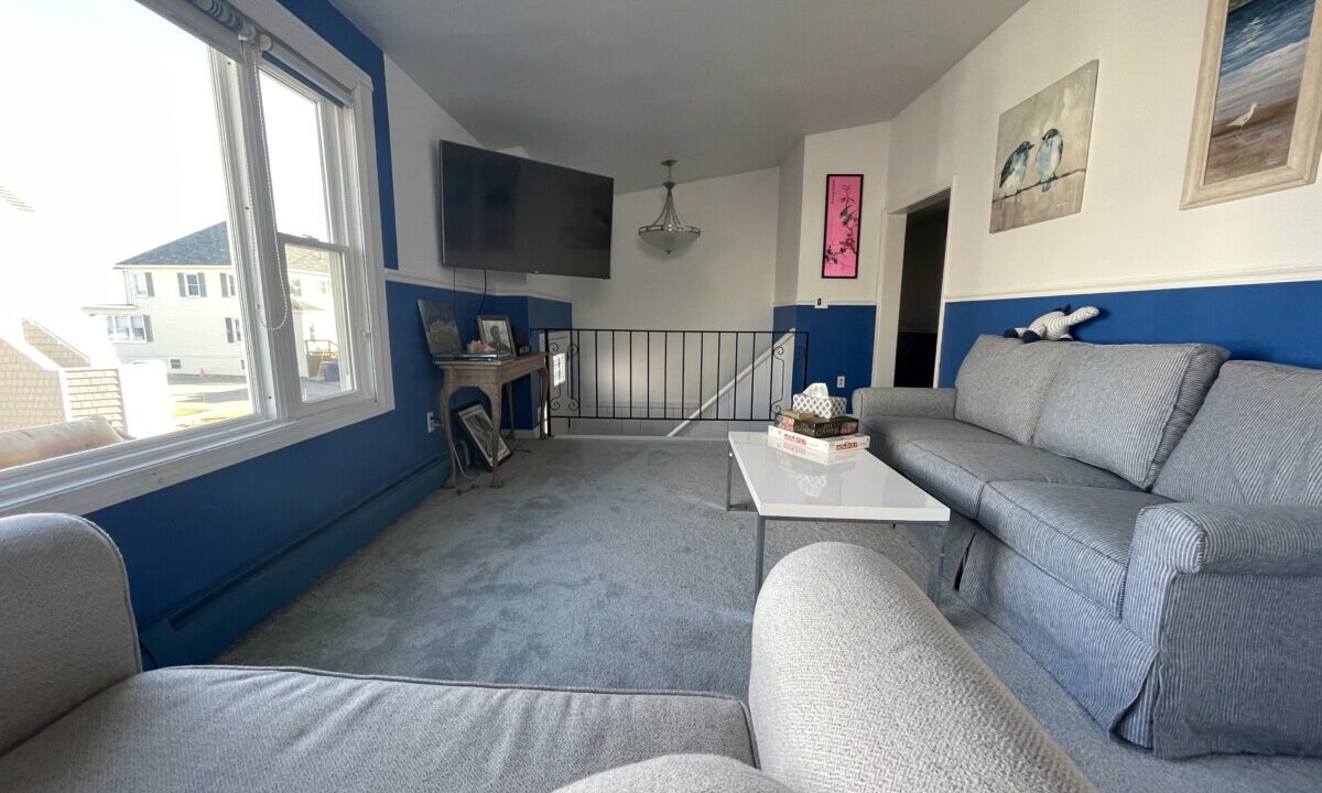 a living room filled with furniture and a flat screen tv.