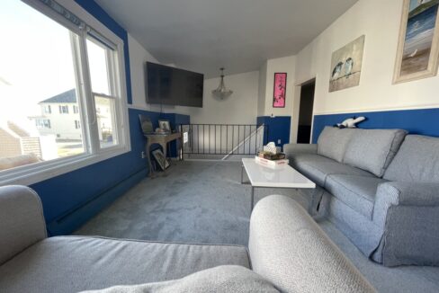 a living room filled with furniture and a flat screen tv.