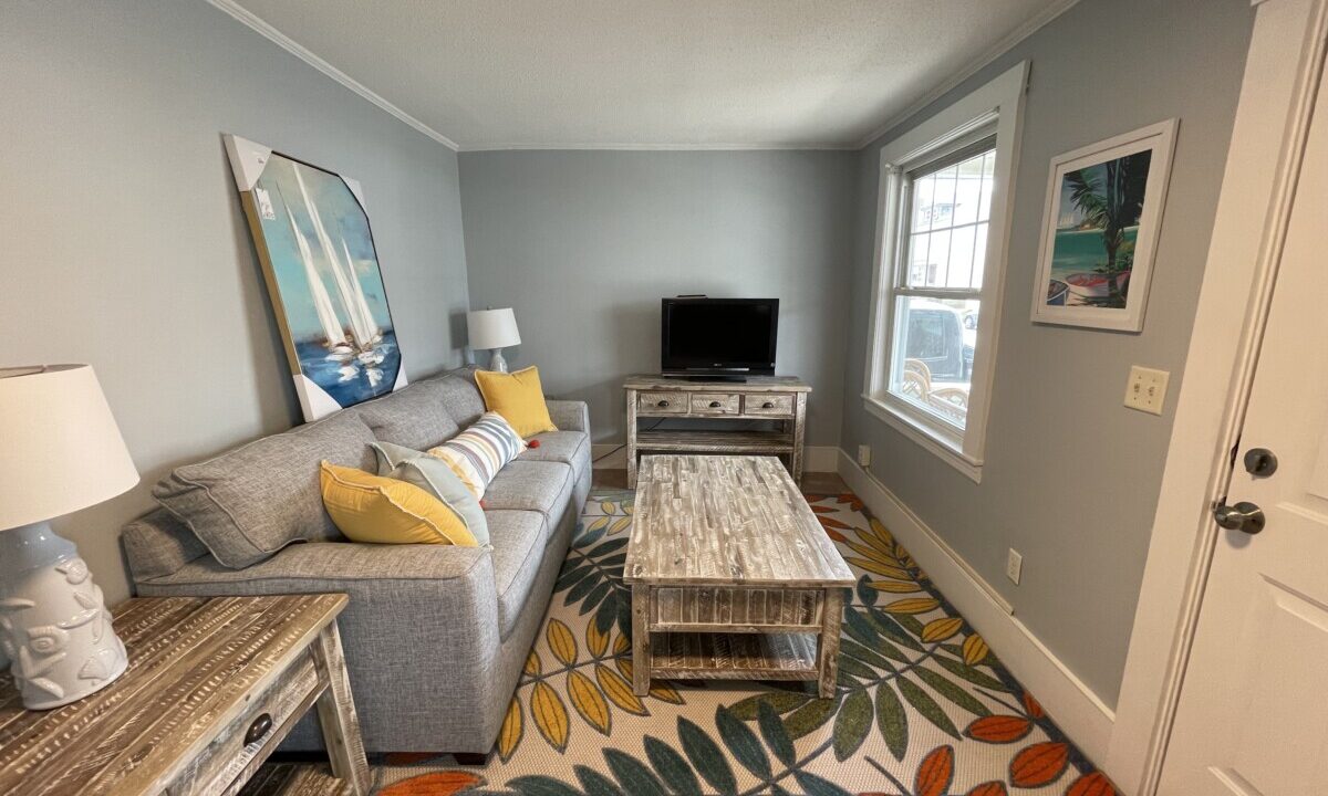 a living room filled with furniture and a flat screen tv.