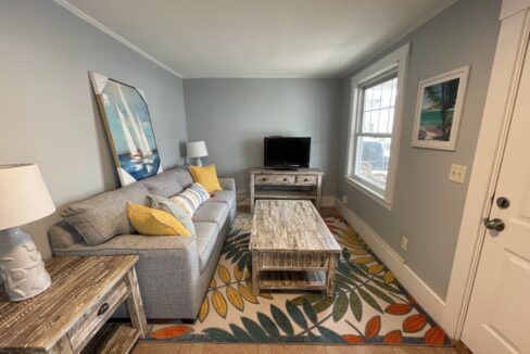 a living room filled with furniture and a flat screen tv.