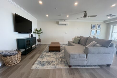 a living room filled with furniture and a flat screen tv.