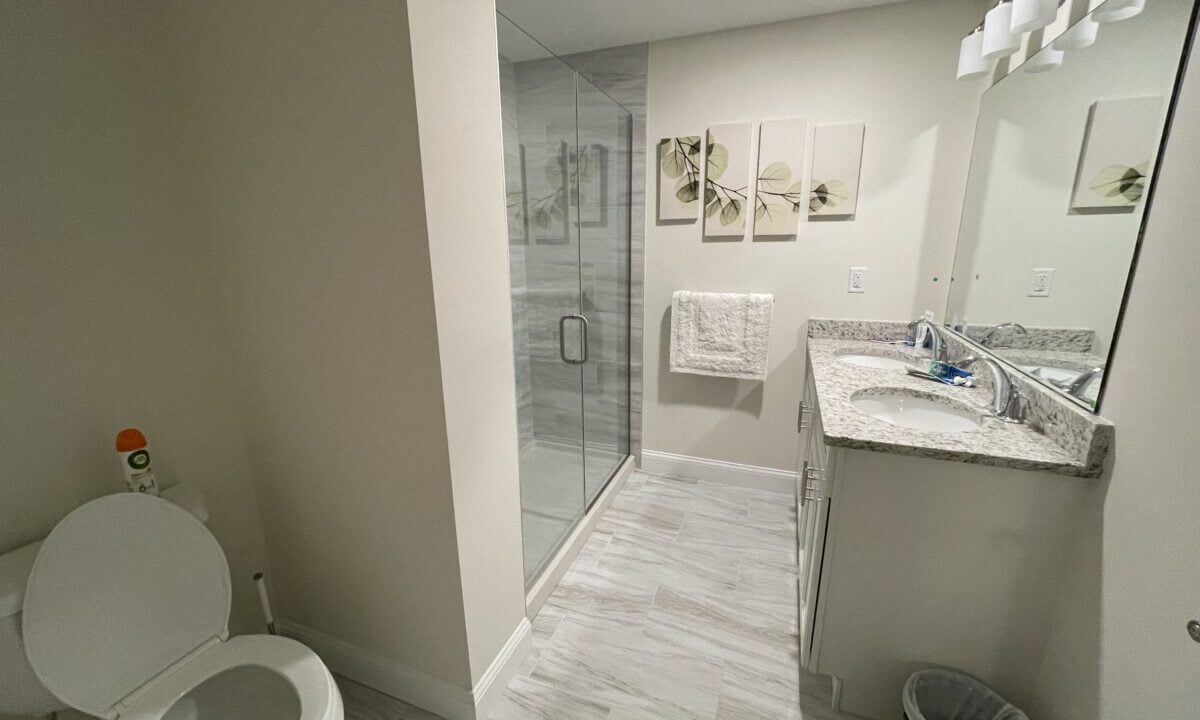a white toilet sitting next to a walk in shower.