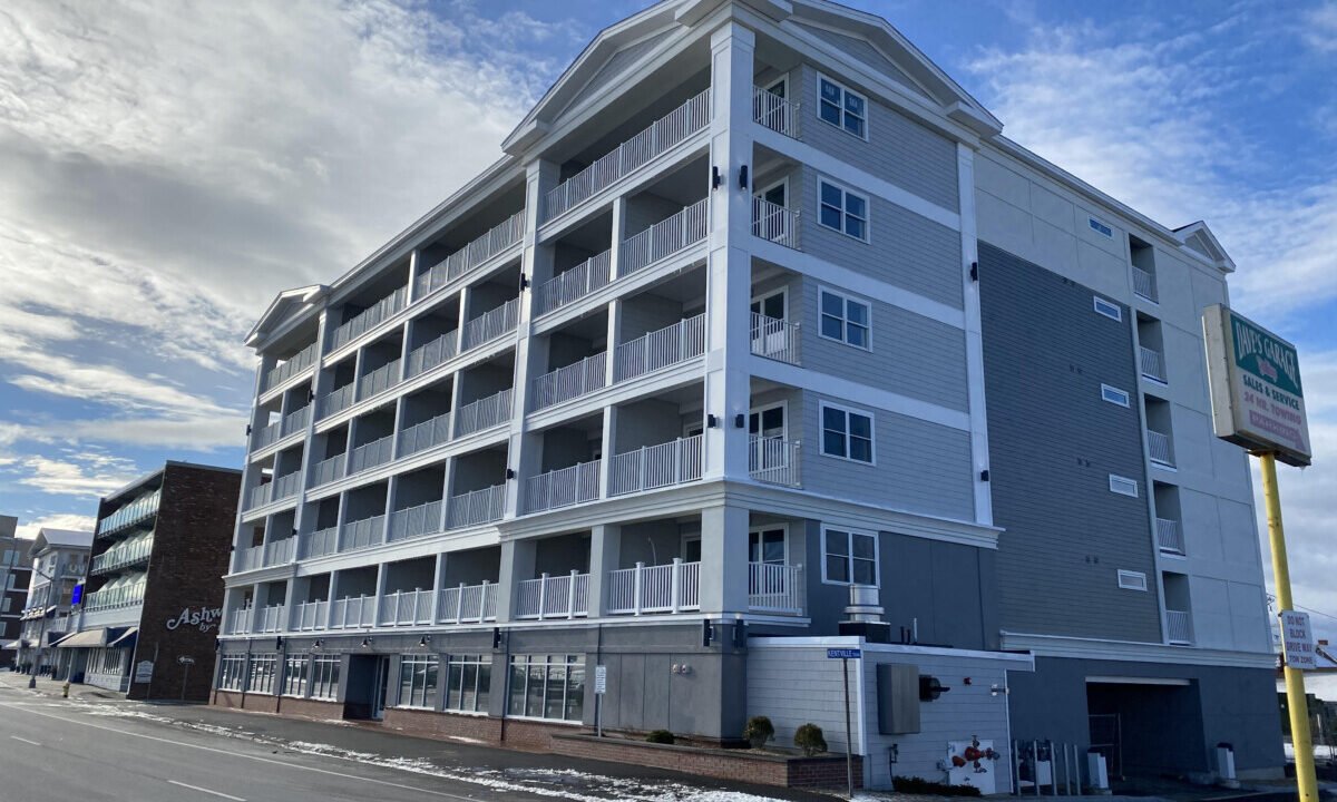 an apartment building on the corner of a street.