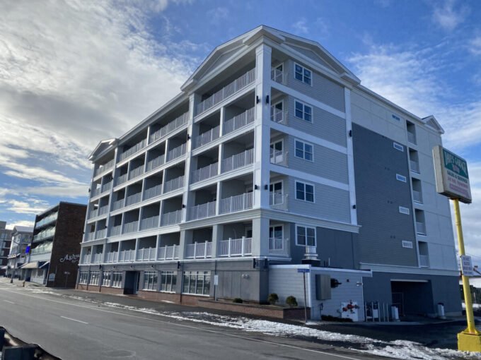 an apartment building on the corner of a street.