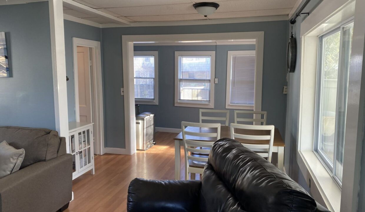 a living room filled with furniture and a wooden floor.