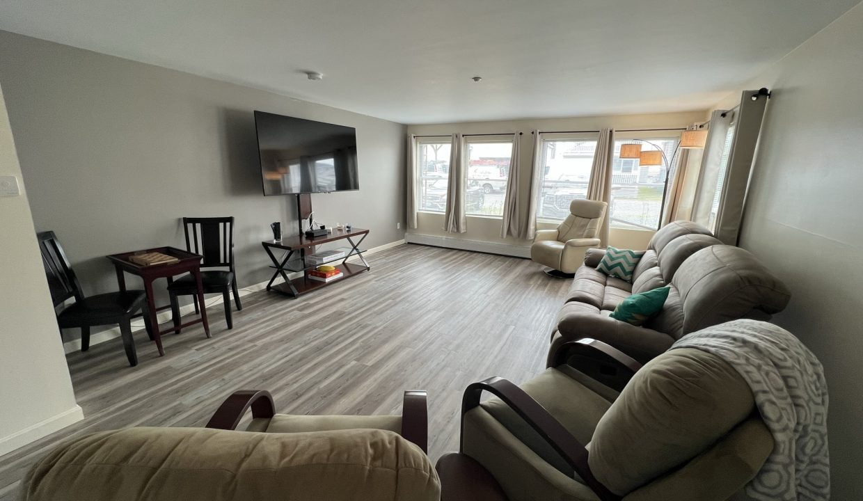 a living room filled with furniture and a flat screen tv.