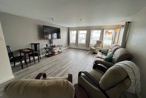 a living room filled with furniture and a flat screen tv.