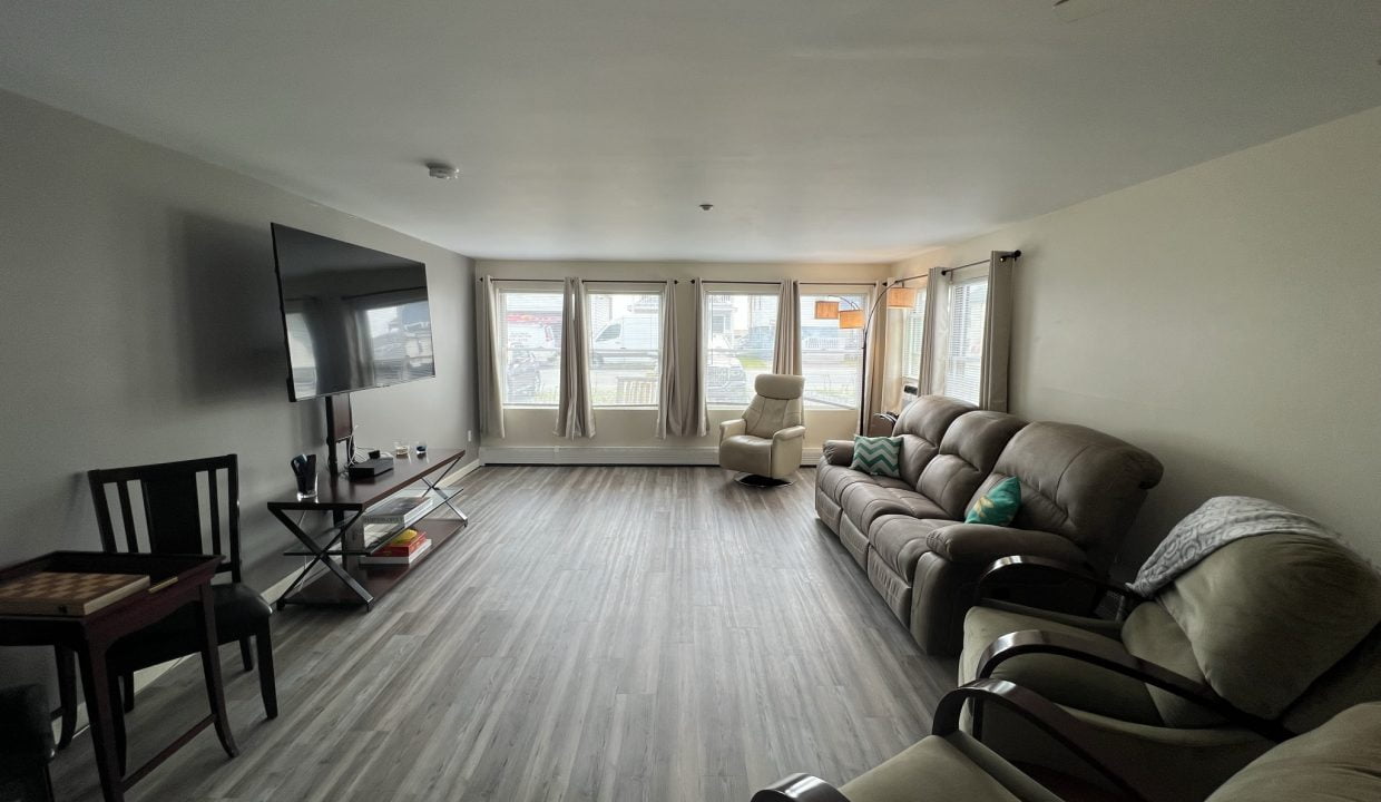 a living room filled with furniture and a flat screen tv.