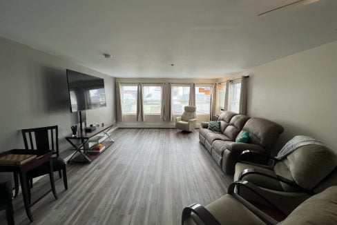 a living room filled with furniture and a flat screen tv.