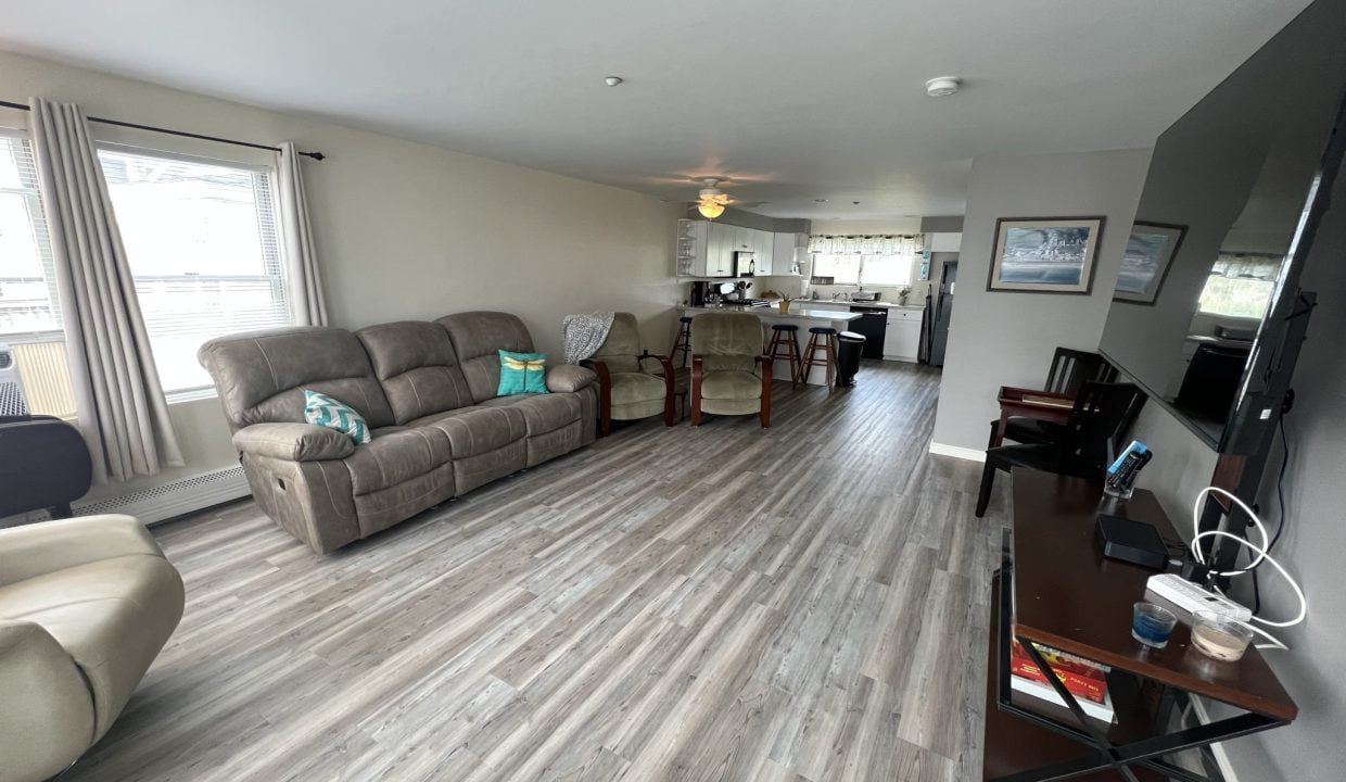 a living room filled with furniture and a flat screen tv.