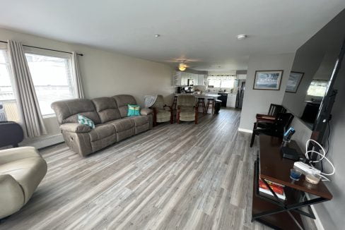 a living room filled with furniture and a flat screen tv.