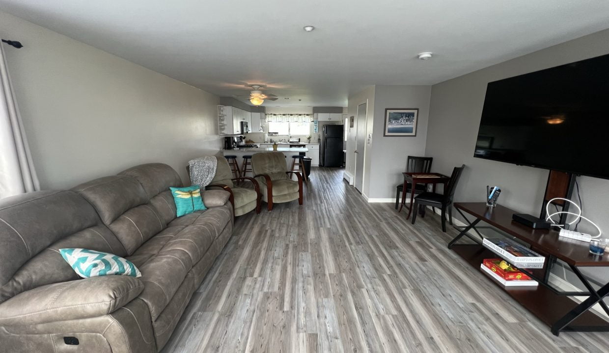 a living room filled with furniture and a flat screen tv.