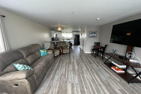 a living room filled with furniture and a flat screen tv.