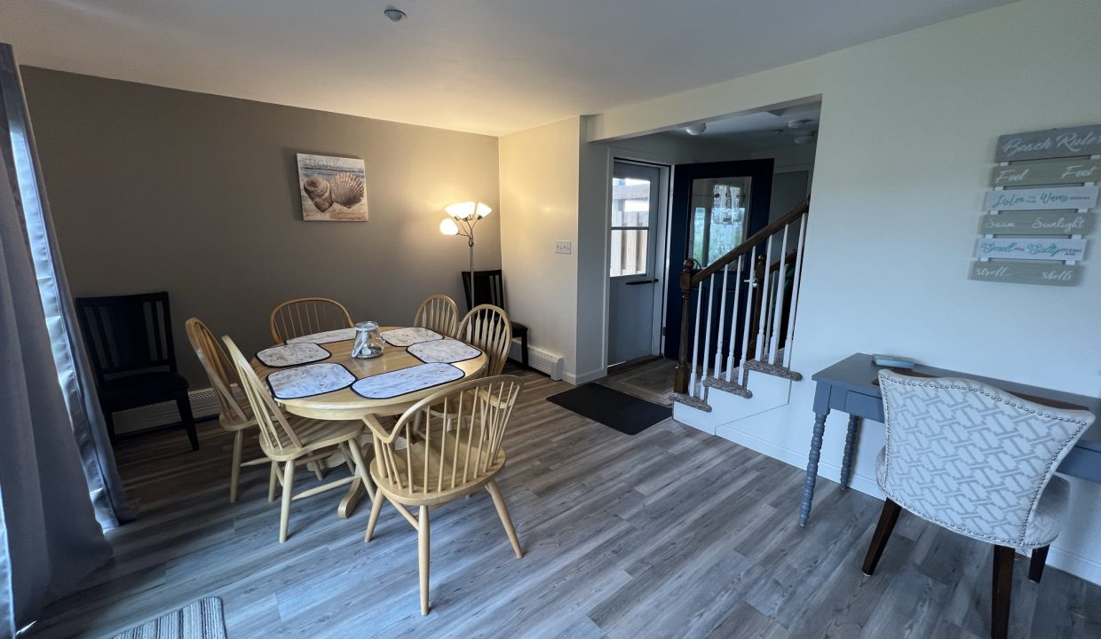 a dining room with a table and chairs.