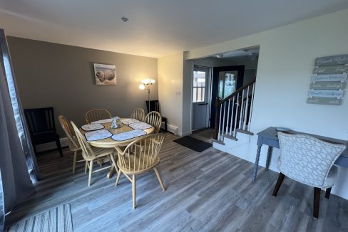 a dining room with a table and chairs.