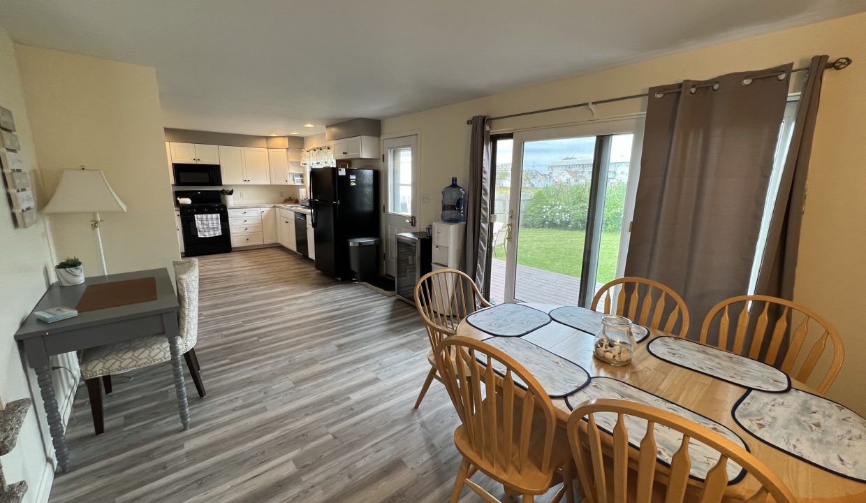 a kitchen and dining room with a large sliding glass door.