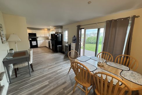 a kitchen and dining room with a large sliding glass door.