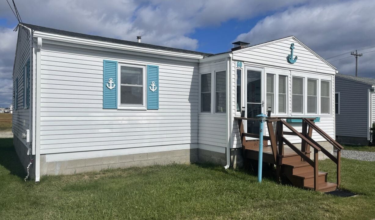 a mobile home with a porch and stairs.
