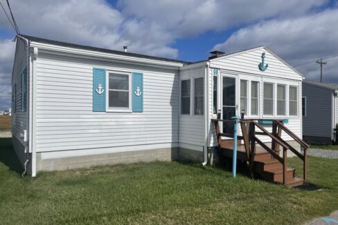 a mobile home with a porch and stairs.