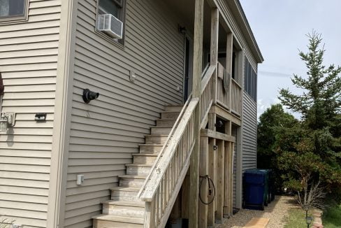 a house with a staircase leading up to the second floor.