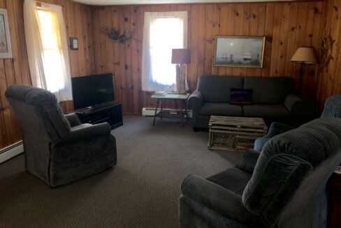 a living room filled with furniture and a flat screen tv.