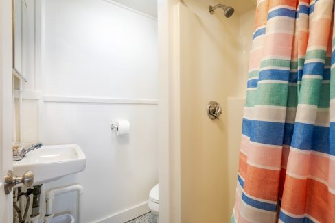 a bathroom with a colorful shower curtain.