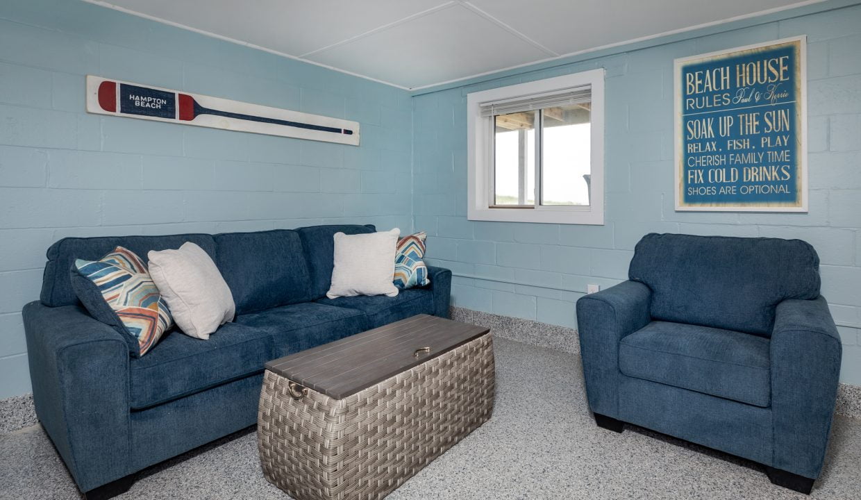 a living room with blue couches and a coffee table.