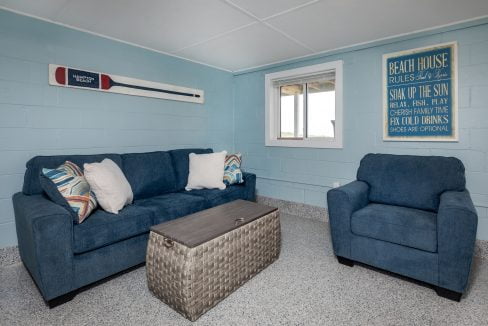 a living room with blue couches and a coffee table.