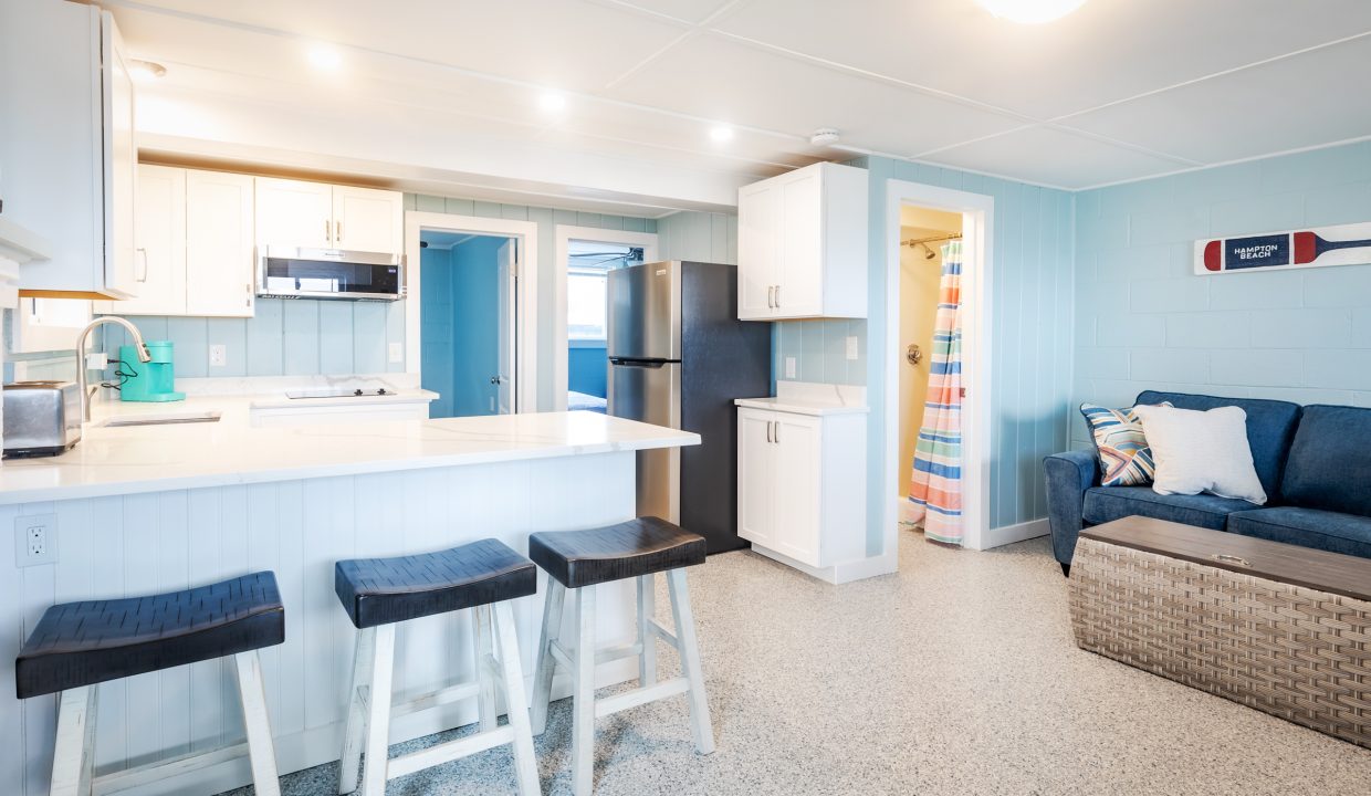 a kitchen with blue walls and a bar stools.