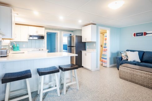 a kitchen with blue walls and a bar stools.