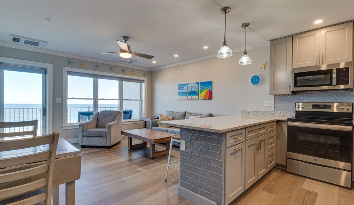 a kitchen and living room with a large window.