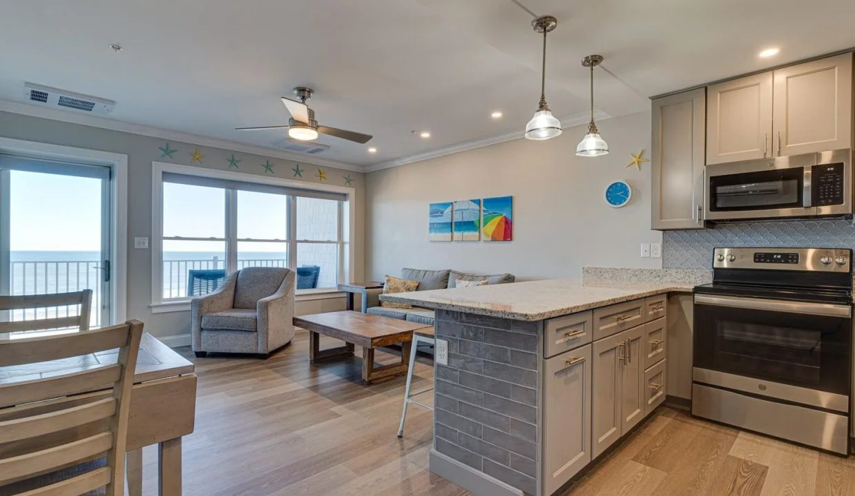 a kitchen and living room with a large window.