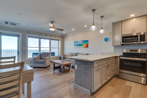 a kitchen and living room with a large window.