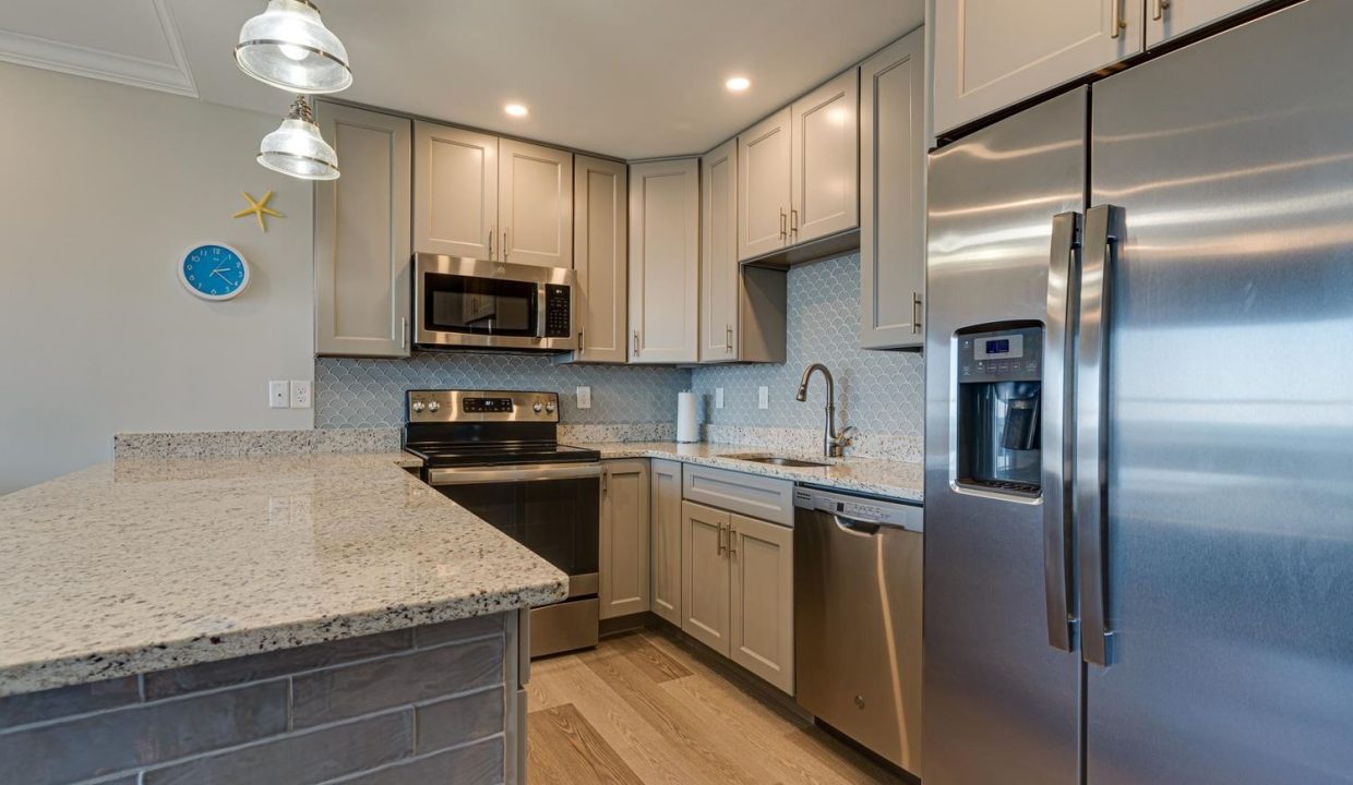 a kitchen with stainless steel appliances and granite counter tops.