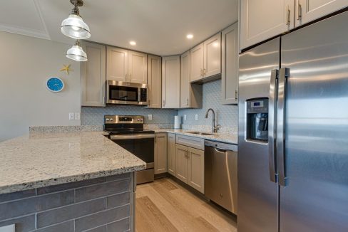 a kitchen with stainless steel appliances and granite counter tops.