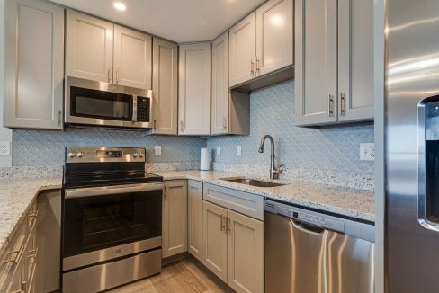 a kitchen with stainless steel appliances and white cabinets.