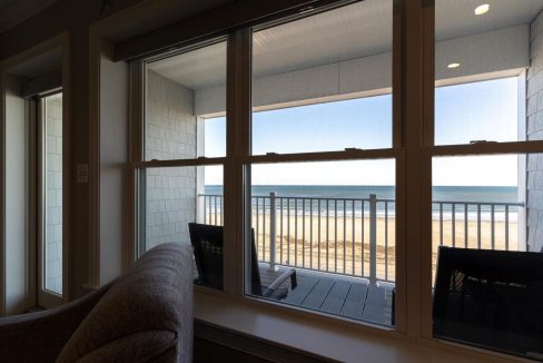 a view of a beach from a living room window.