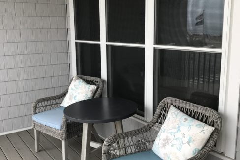 a couple of chairs sitting on top of a wooden floor.