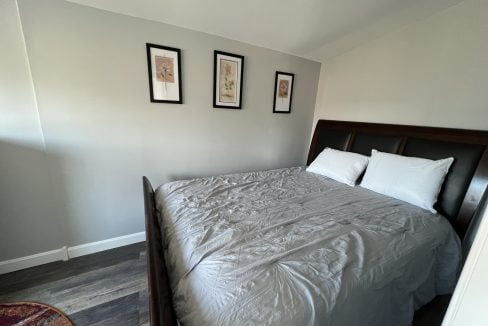 a bedroom with a bed and pictures on the wall.
