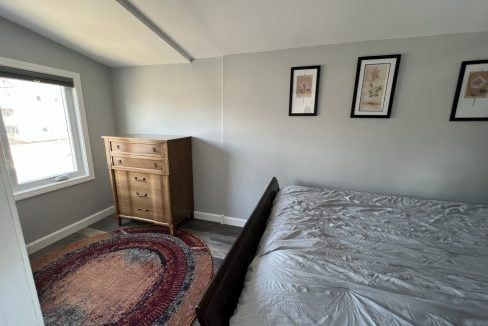 a bedroom with a bed and a dresser.