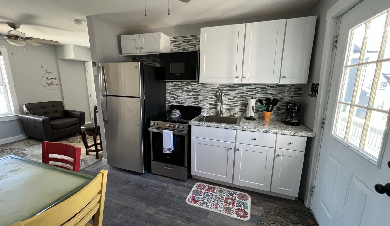 a kitchen with white cabinets and a black stove top oven.