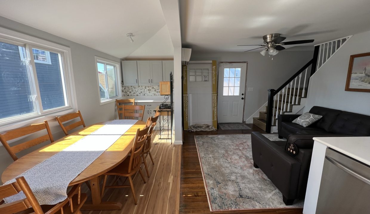 a living room and dining room with hardwood floors.